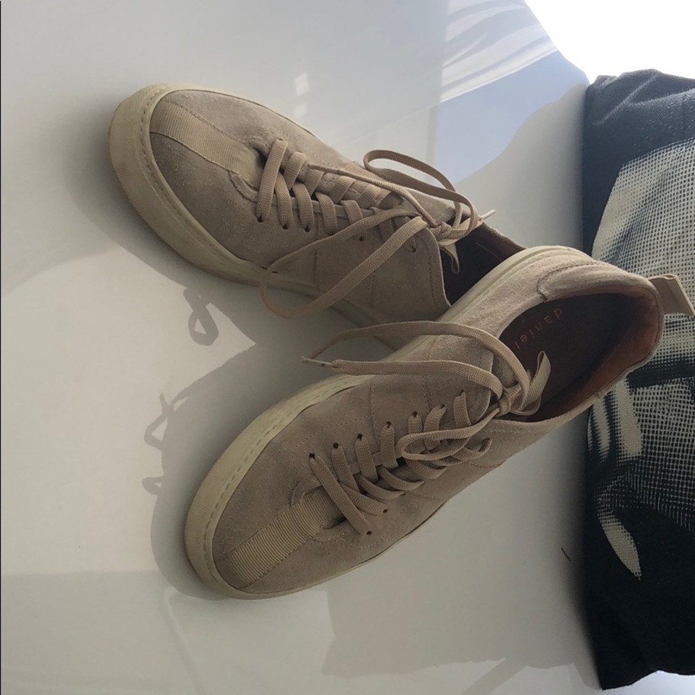 Beige suede sneakers with brown leather interior